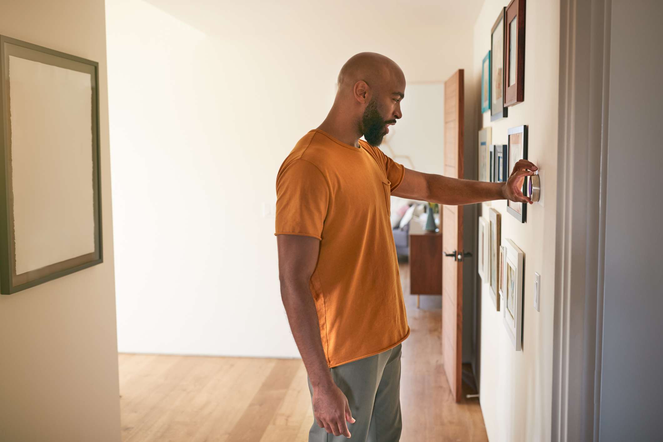 Man-Adjusting-Digital-Thermostat