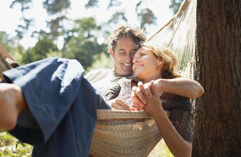Relaxed couple on a hammock, enjoying financial peace with the best CD rates in VT.