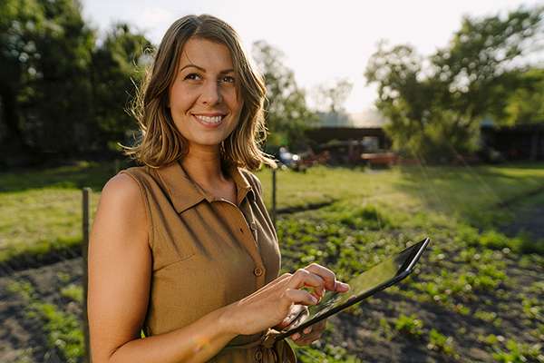 HiRes small - woman on ipad with farm