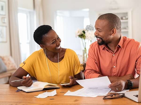 couple doing paper work at table