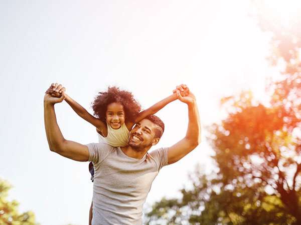 dad with daughter on shoulder